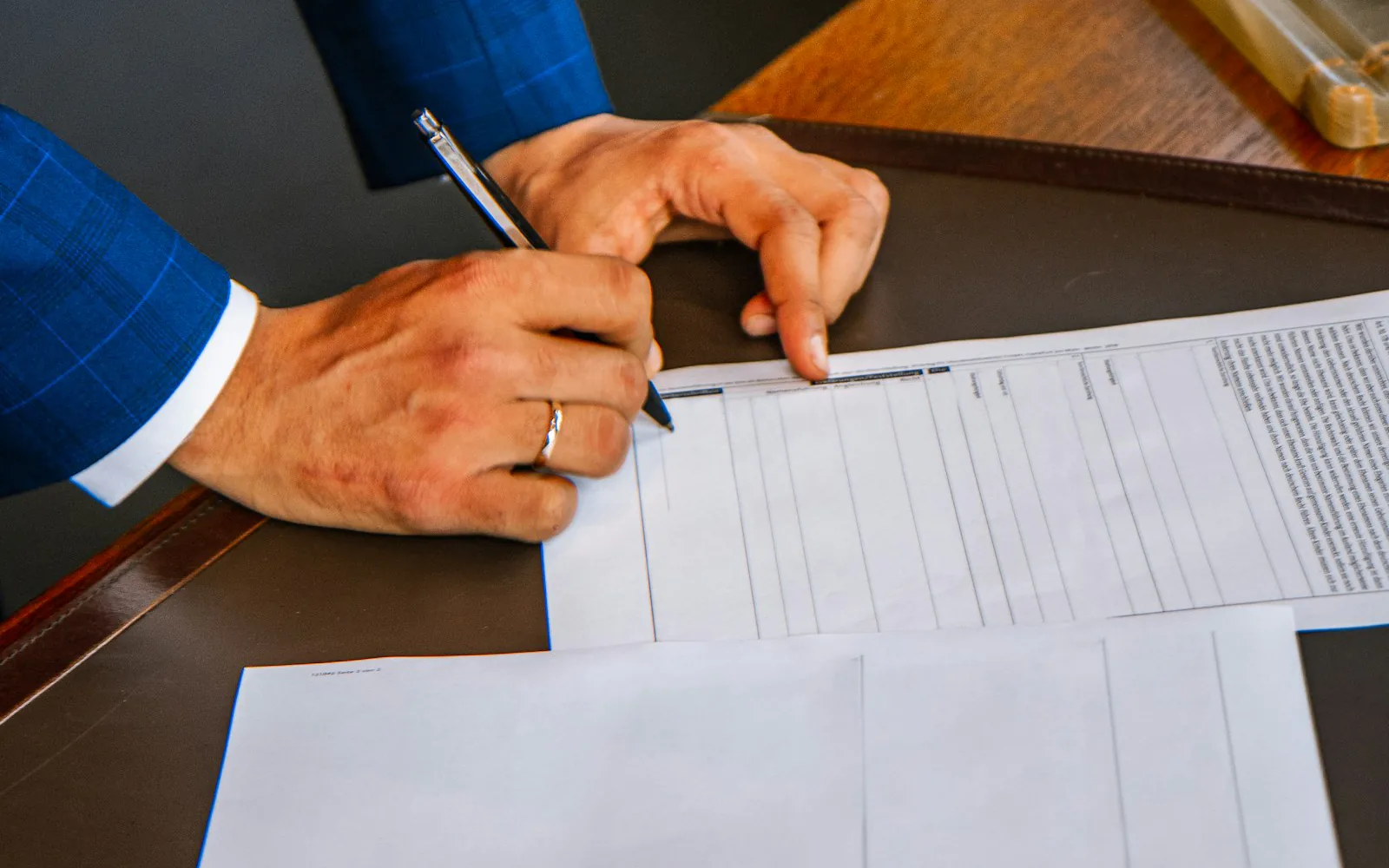 Legal counsel reviewing and annotating a regulatory document at a boardroom table