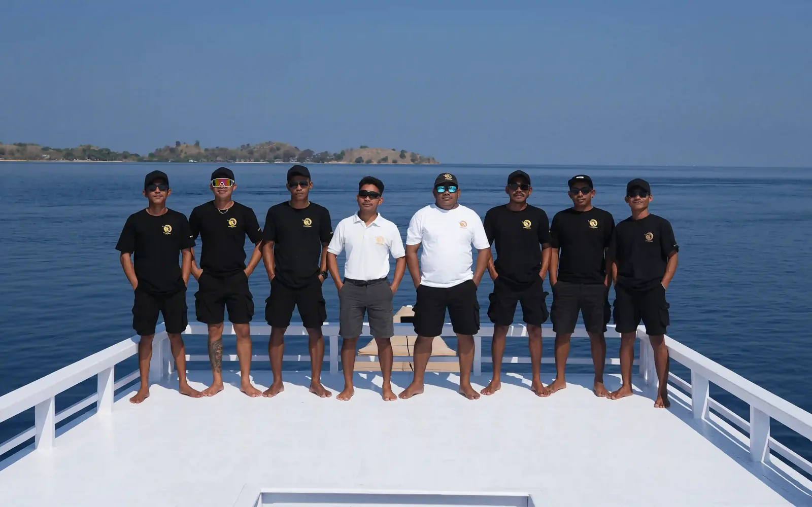 A full vessel crew assembled on the foredeck of a charter phinisi