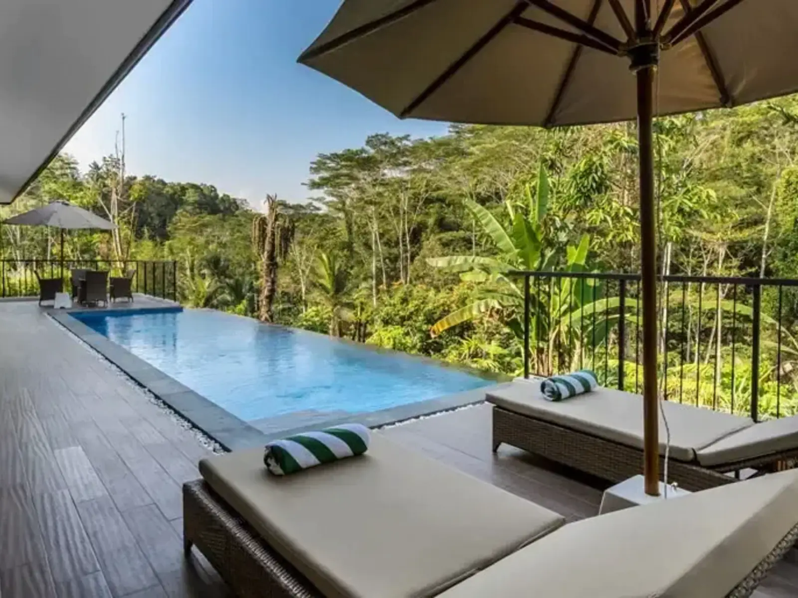 A private pool terrace with loungers at a staffed villa above the valley